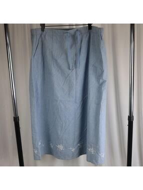 Classic Elements chambray midi skirt in light blue with white floral embroidery.